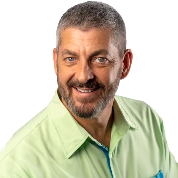Joe Matuella, smiling, with short grey hair and a beard, wearing a light green shirt